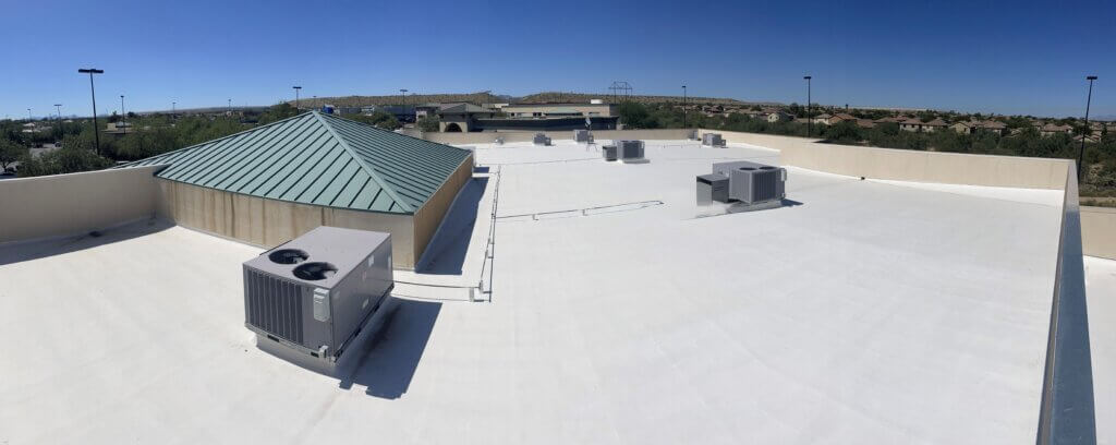The roof of a commercial building in Tucson that has recently had a white roof coating applied